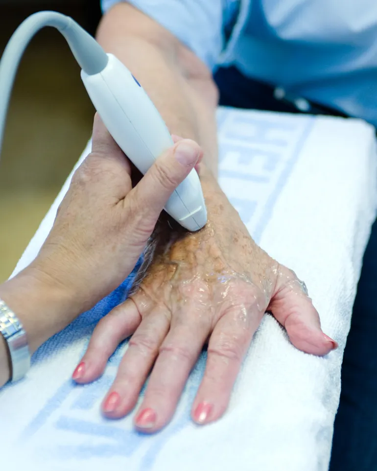 A doctor holding a patient's hand