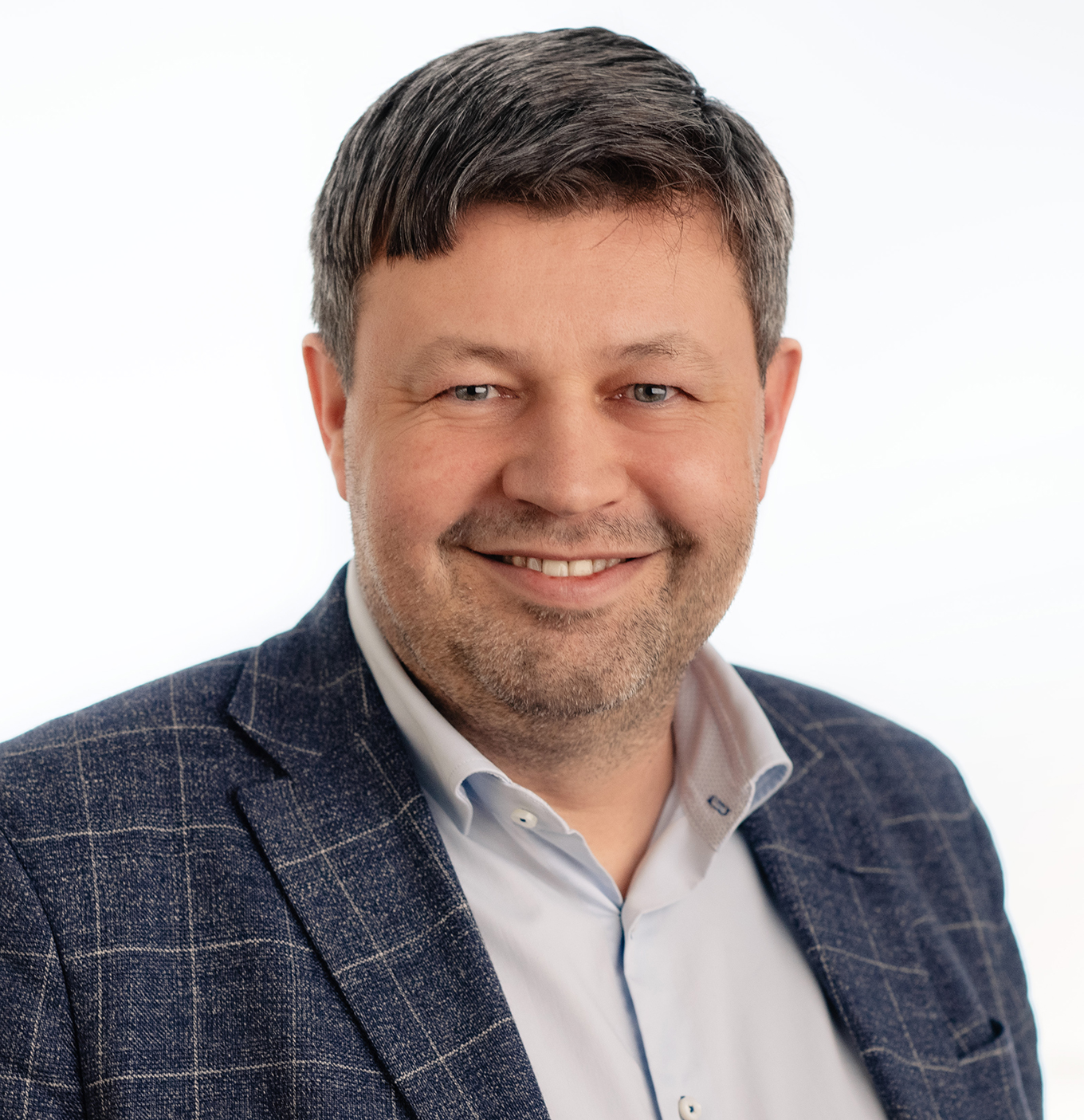 En mann som smiler til kameraet