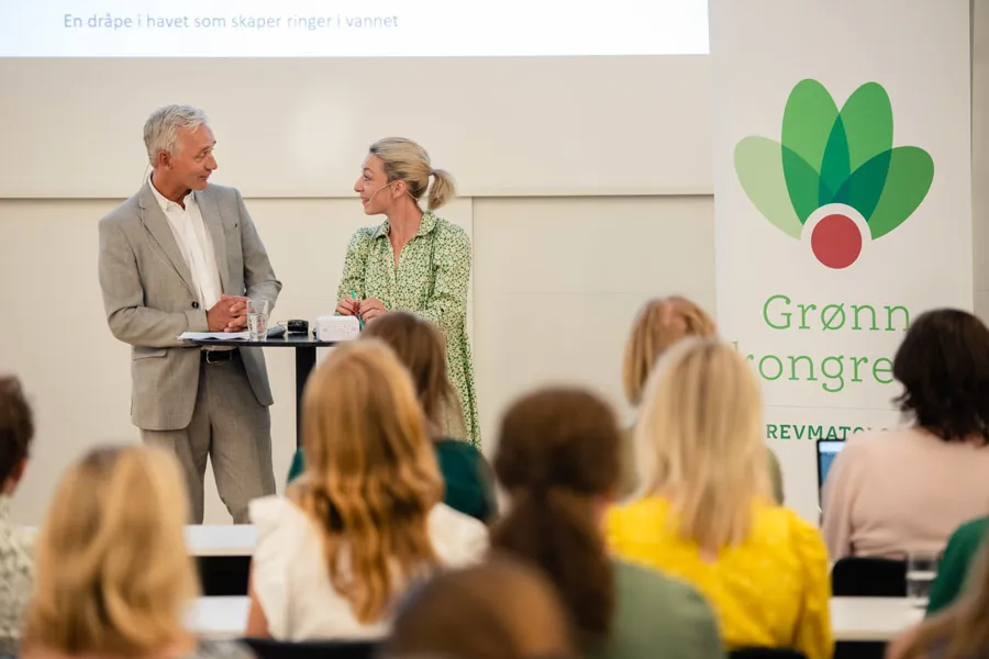 En mann og en kvinne som snakker med en gruppe mennesker