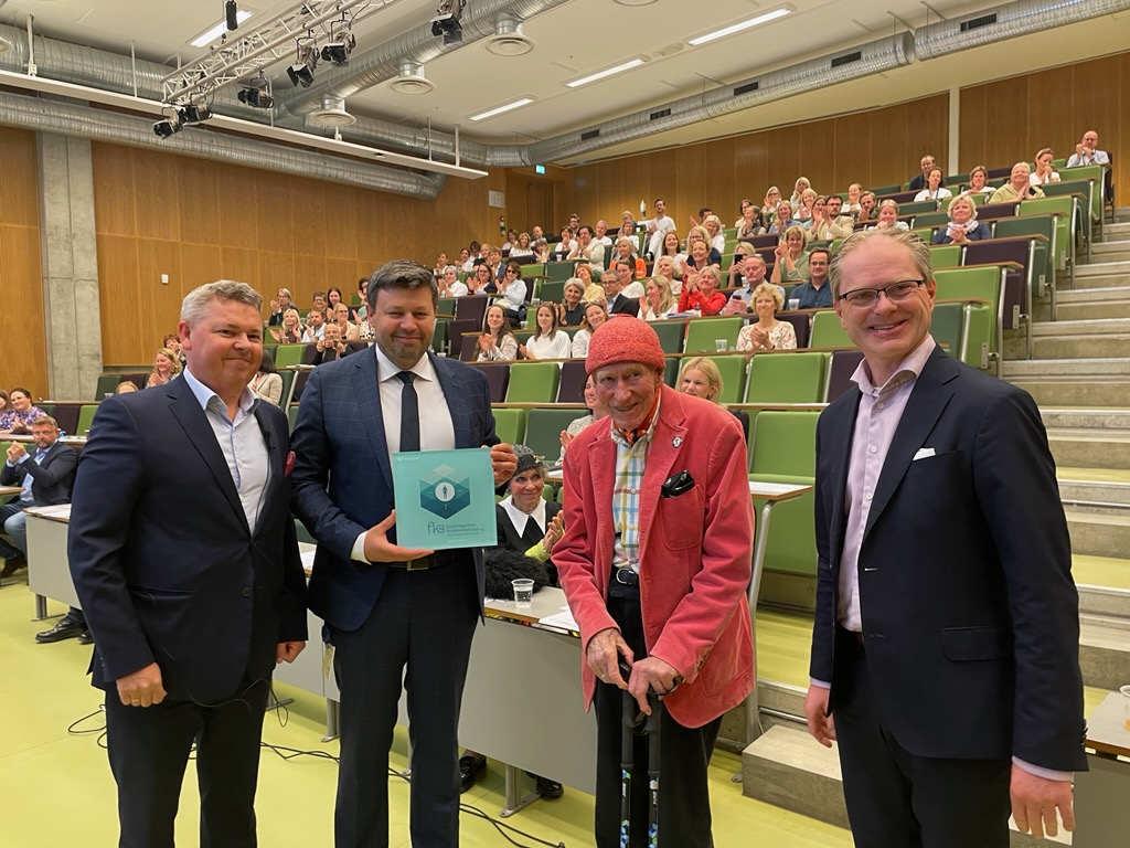 En gruppe mennesker som står i en hall