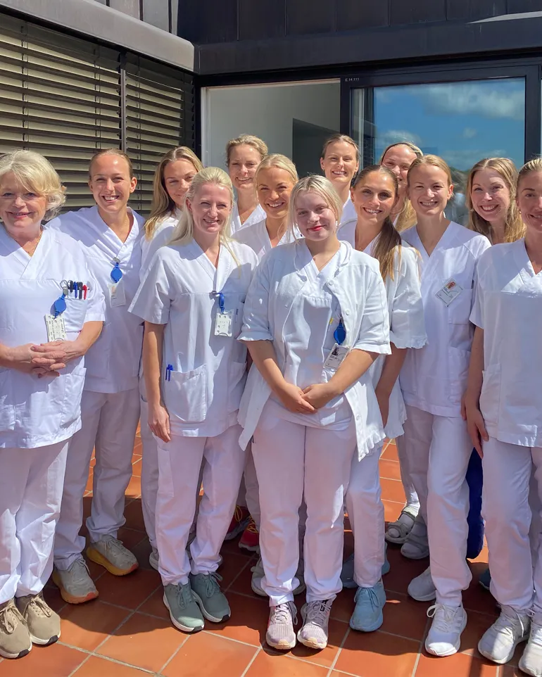 A group of people wearing white lab coats