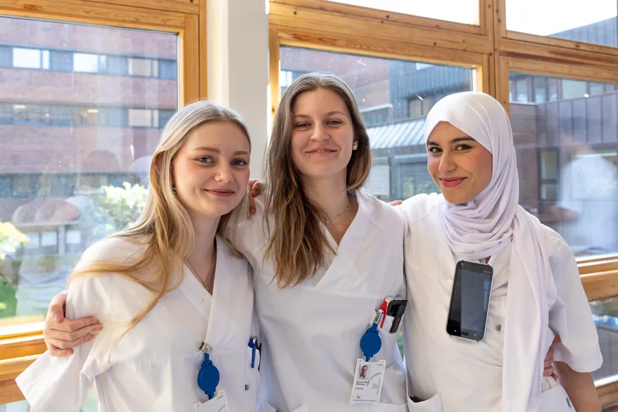 En gruppe kvinner iført hvite frakker