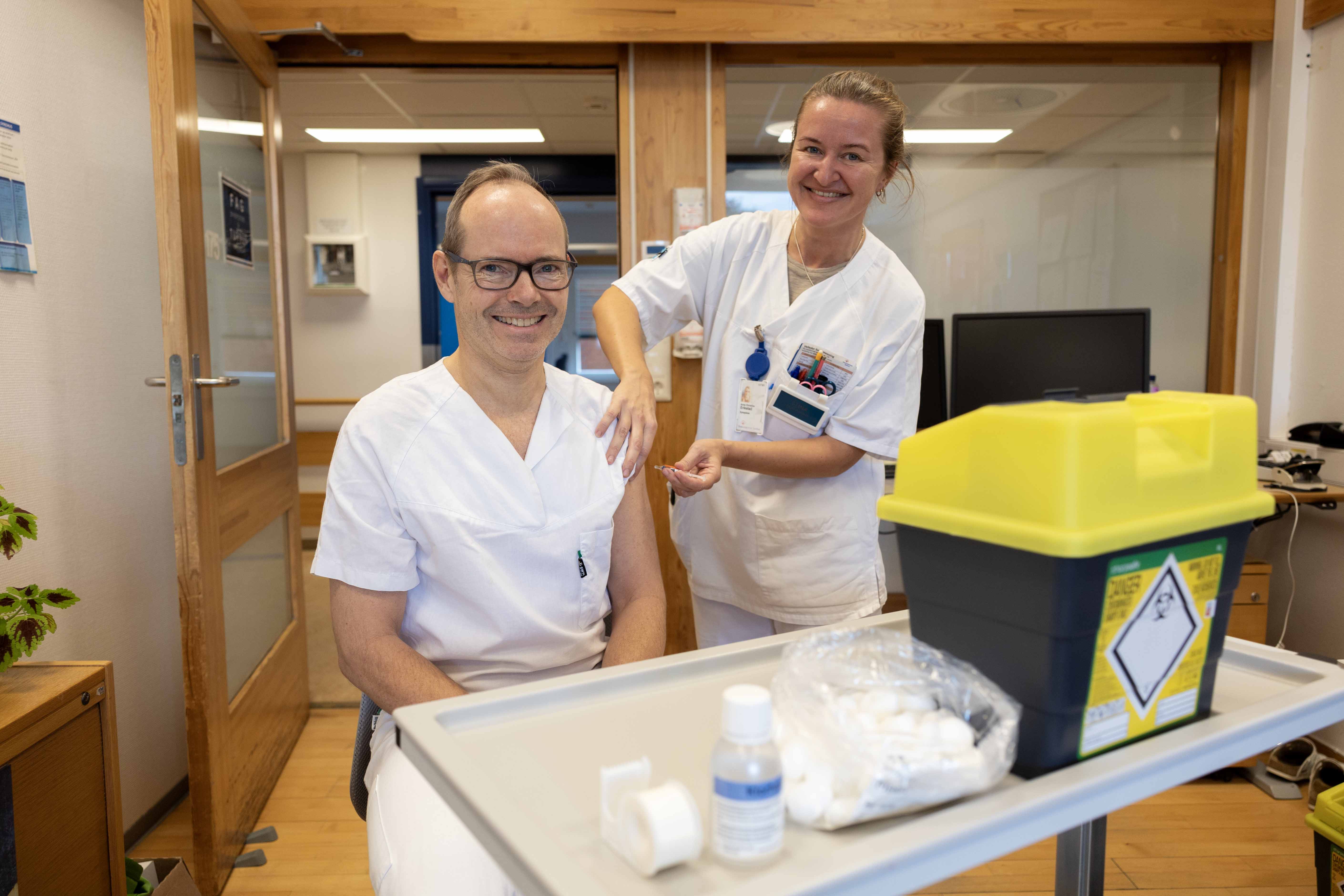 En mann og en kvinne i hvite frakker som står i et rom