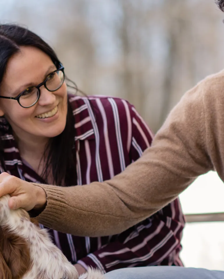 Kvinne og mann sitter sammen med en hund