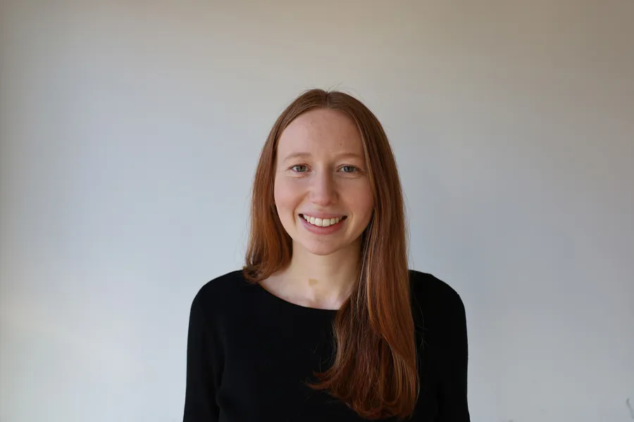 En kvinne som smiler til kameraet